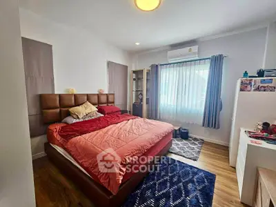 Spacious bedroom with modern decor and natural light, featuring a large bed and stylish furnishings.