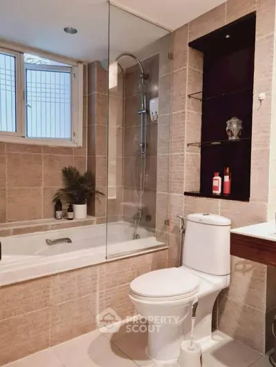 Modern bathroom with bathtub and shower in elegant tiled design