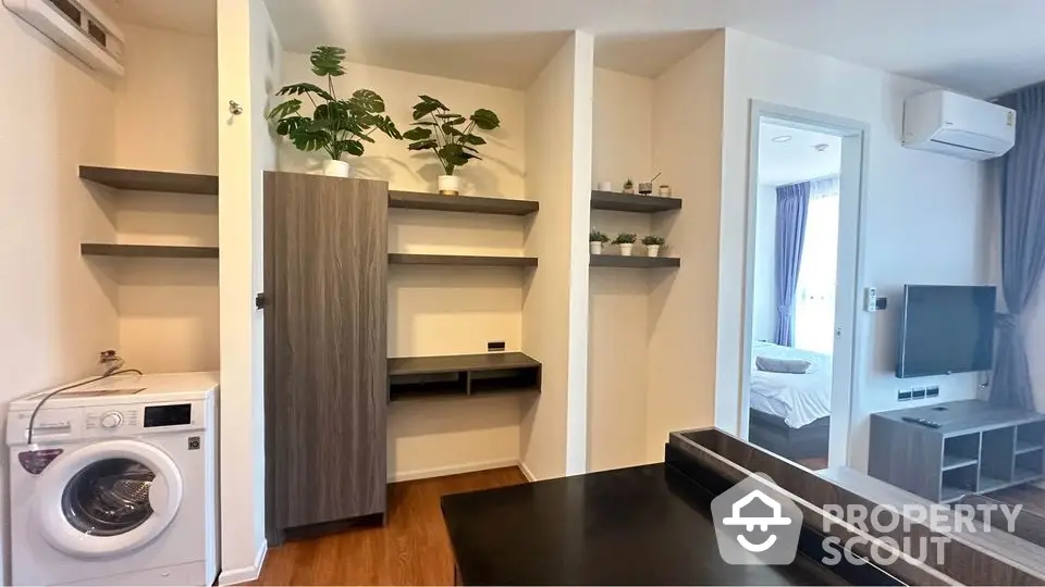 Modern apartment interior with washing machine and stylish shelving