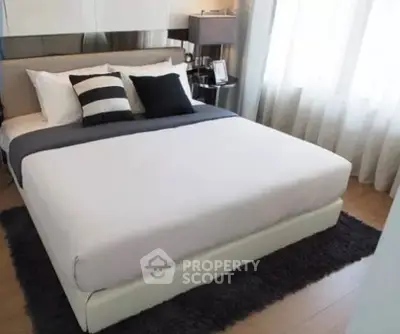 Modern bedroom with stylish decor and natural light