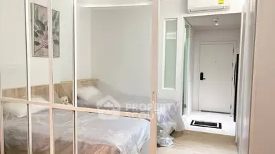 Modern bedroom with sliding glass doors and air conditioning, showcasing a cozy and minimalist design.