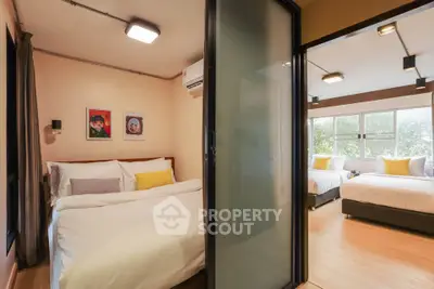 Modern bedroom with large windows and cozy decor, perfect for relaxation.