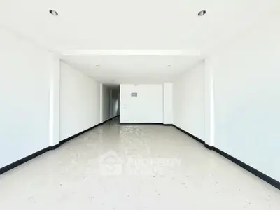 Spacious empty room with white walls and tiled floor, ideal for customization.