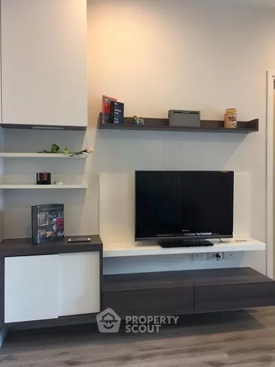 Modern living room with sleek TV unit and stylish shelving, perfect for contemporary living.