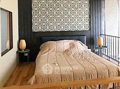 Stylish bedroom with modern decor and cozy ambiance, featuring elegant lighting and patterned accent wall.