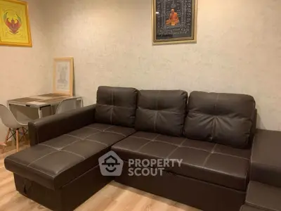 Cozy living room with dark leather sectional sofa and modern decor