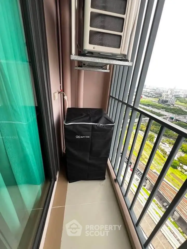 Compact balcony with air conditioning unit and city view, ideal for urban living.
