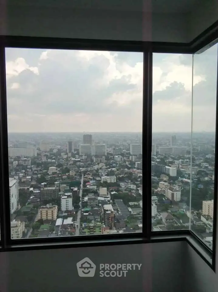 Stunning cityscape view from high-rise apartment window, showcasing urban skyline and expansive horizon.