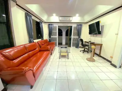 Spacious living room with red leather sofas and modern decor