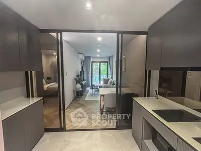 Modern open-layout kitchen with sleek design and view into stylish living area