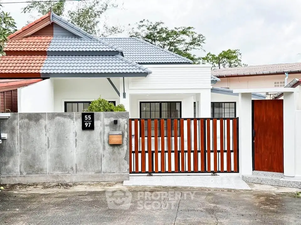 Charming modern house with stylish gate and unique roof design