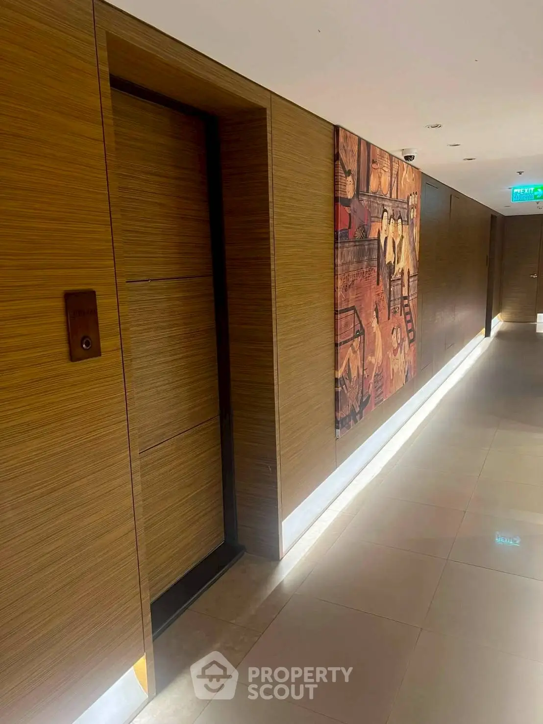 Modern hallway with wooden paneling and artistic wall decor in a luxury building.
