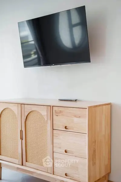 Modern living room with mounted TV and stylish wooden cabinet