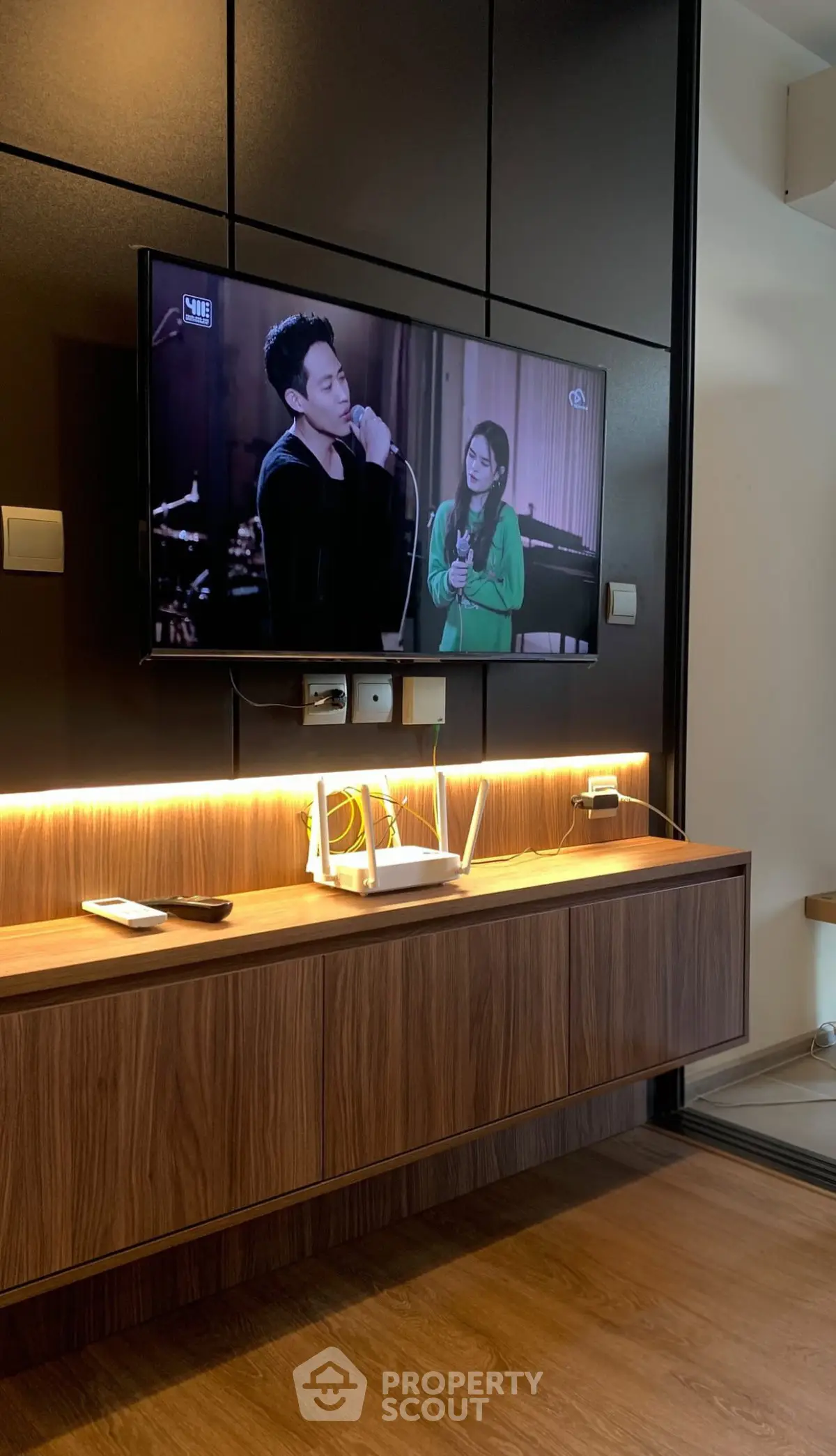 Modern living room with wall-mounted TV and stylish wooden console