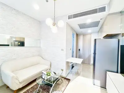 Modern living room with sleek design, featuring a cozy sofa, stylish lighting, and contemporary decor.