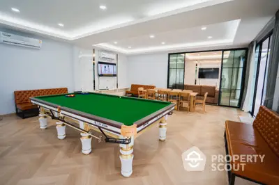 Luxurious recreation room with billiards table and modern seating area