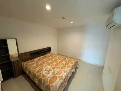 Cozy bedroom with modern design and air conditioning unit, perfect for relaxation.