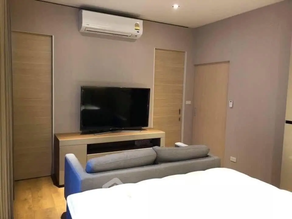 Modern living room with sleek TV setup and comfortable sofa