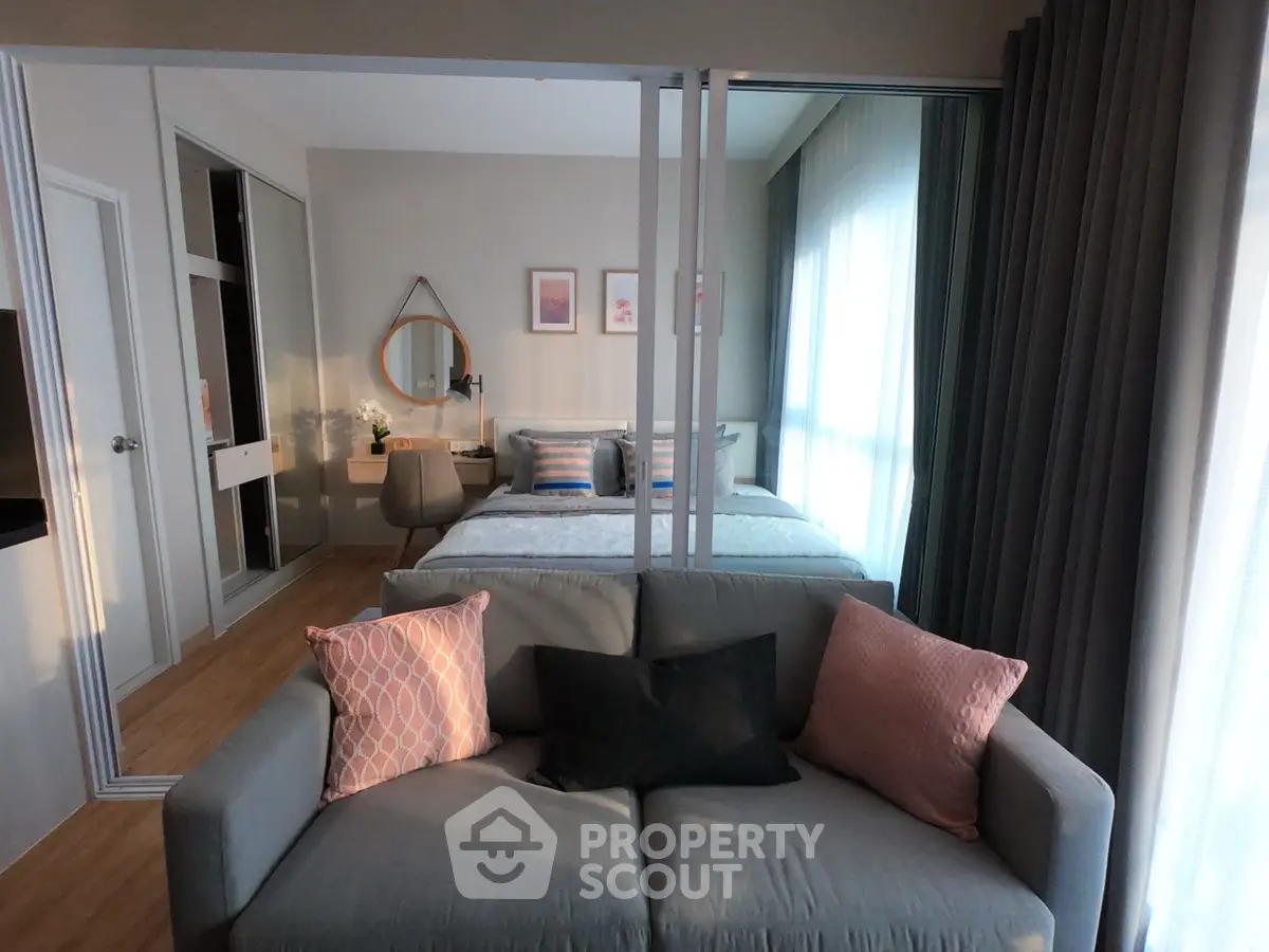 Modern studio apartment with cozy living area and stylish bedroom decor.