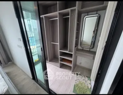 Modern walk-in closet with sleek design and ample storage space in a high-rise apartment.