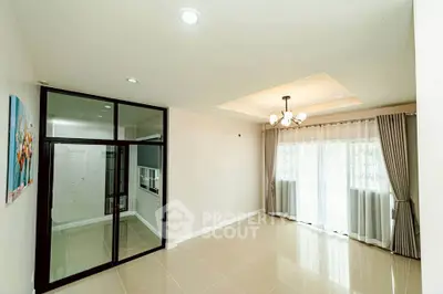 Spacious living room with elegant lighting and large windows for natural light.