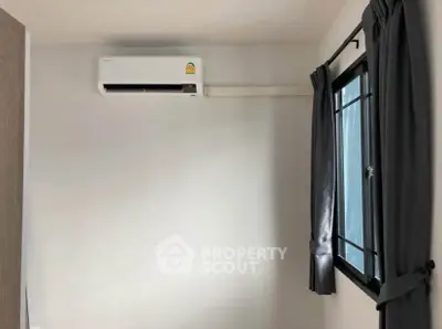 Minimalist room with air conditioning and window, perfect for comfort and relaxation.