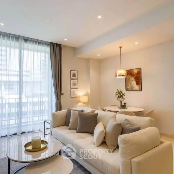 Elegant living room with modern decor and large windows in a luxury apartment.