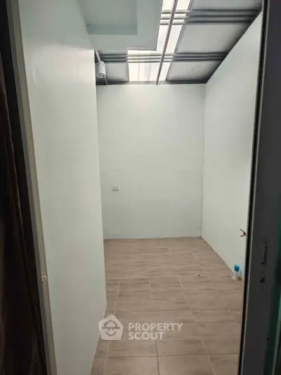 Spacious storage room with tiled floor and natural light