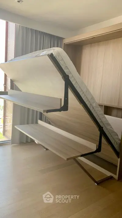 Modern bedroom with innovative foldable bed design and wooden flooring