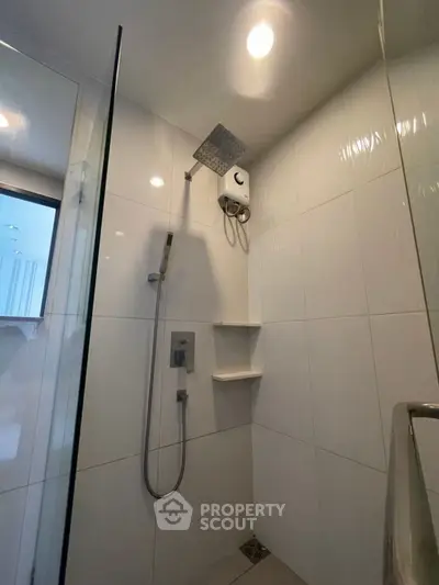 Modern bathroom with sleek shower and white tiles