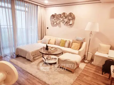 Elegant living room with cozy sofa, stylish decor, and natural light from large windows.