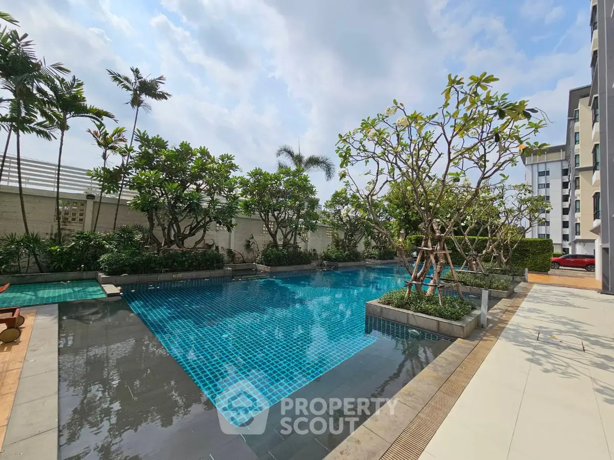 Luxurious residential pool area with lush greenery and modern design