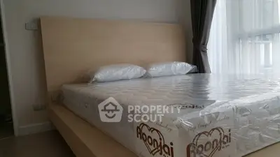 Modern bedroom with stylish wooden bed and large window for natural light.