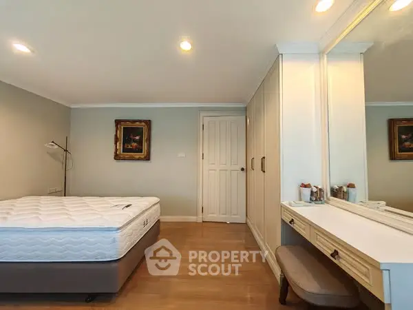 Spacious bedroom with elegant decor and ample storage space