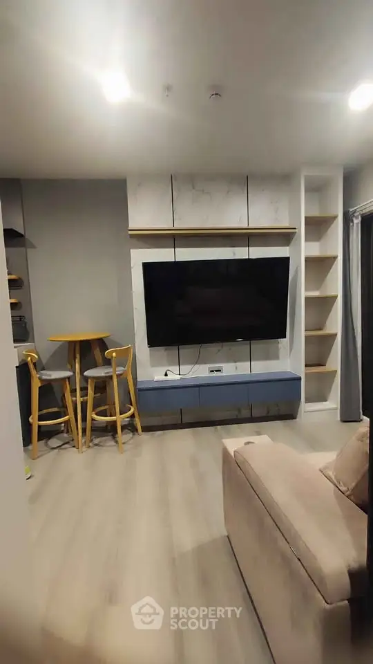 Modern living room with sleek TV setup and cozy seating area