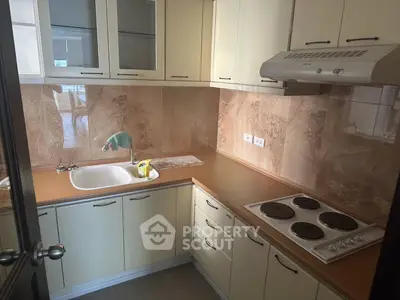 Charming kitchen with closed layout and modern appliances, perfect for culinary enthusiasts.