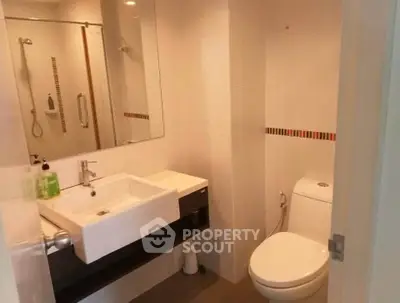 Modern bathroom with sleek fixtures and spacious shower area.