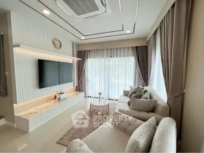 Luxurious living room with elegant decor, plush sofas, and modern entertainment setup.
