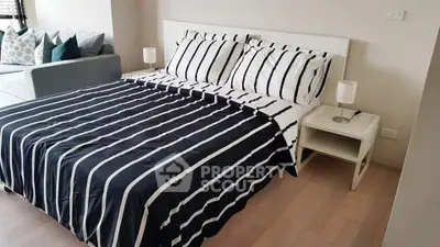 Modern bedroom with stylish striped bedding and cozy ambiance