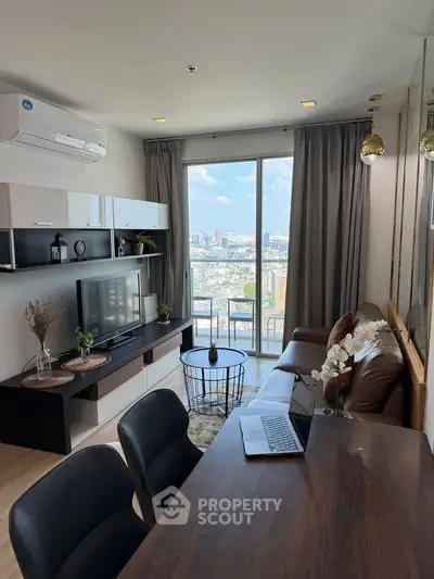 Modern living room with city view, stylish furniture, and natural light.