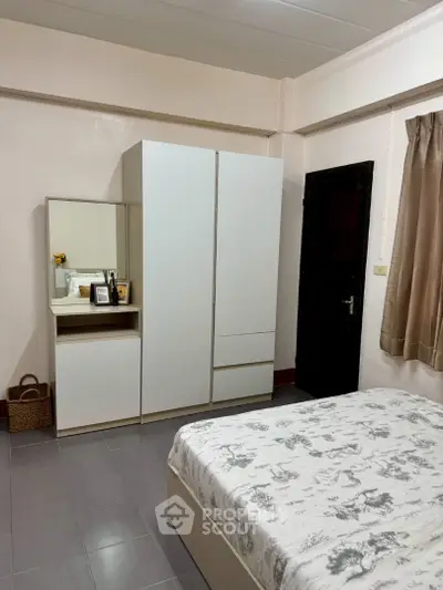 Cozy bedroom with modern wardrobe and elegant decor, perfect for comfortable living.