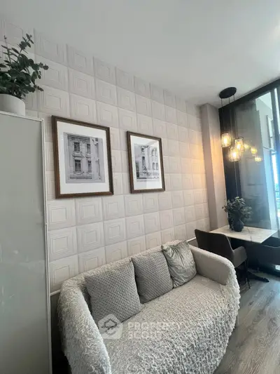 Stylish living room with cozy sofa and elegant wall decor in modern apartment.