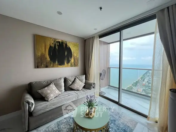 Luxurious living room with stunning ocean view from high-rise balcony.