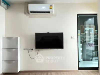 Modern living room with wall-mounted TV and air conditioning unit