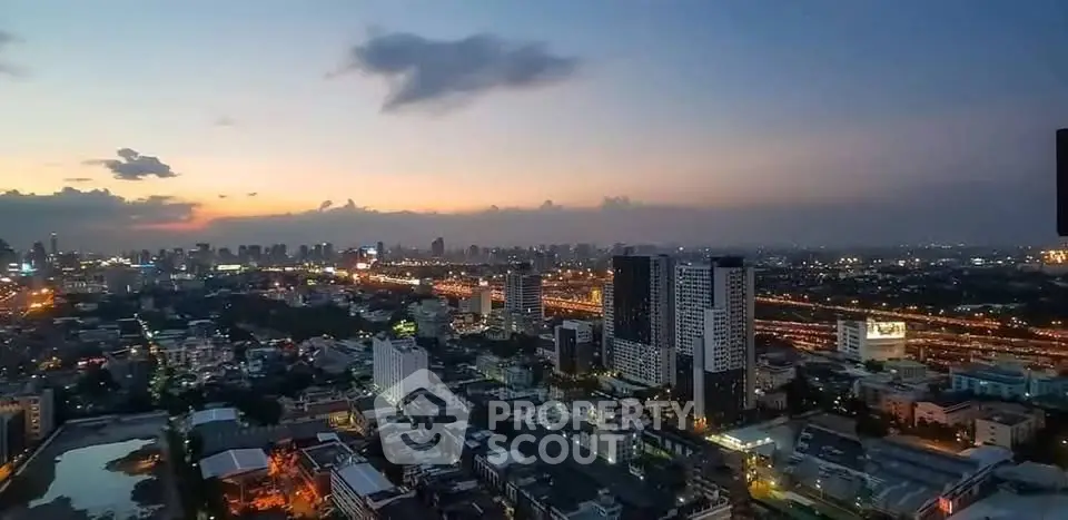 Stunning cityscape view at dusk with illuminated skyline and vibrant urban life.