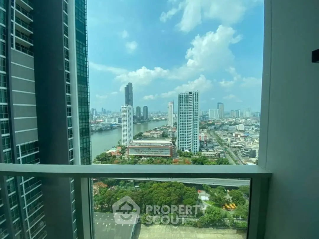 Stunning cityscape view from high-rise balcony overlooking river and skyline.