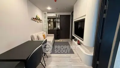 Modern living room with sleek furniture and built-in TV unit in a stylish apartment.