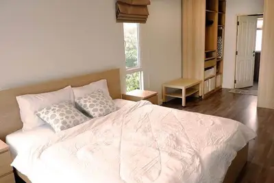 Spacious bedroom with modern decor and ample natural light