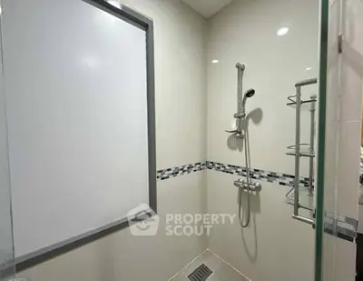 Modern bathroom with sleek shower design and elegant tile accents.