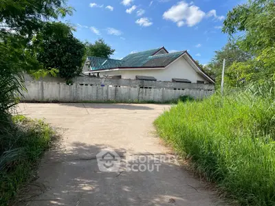 Charming suburban house with lush greenery and spacious driveway, perfect for serene living.